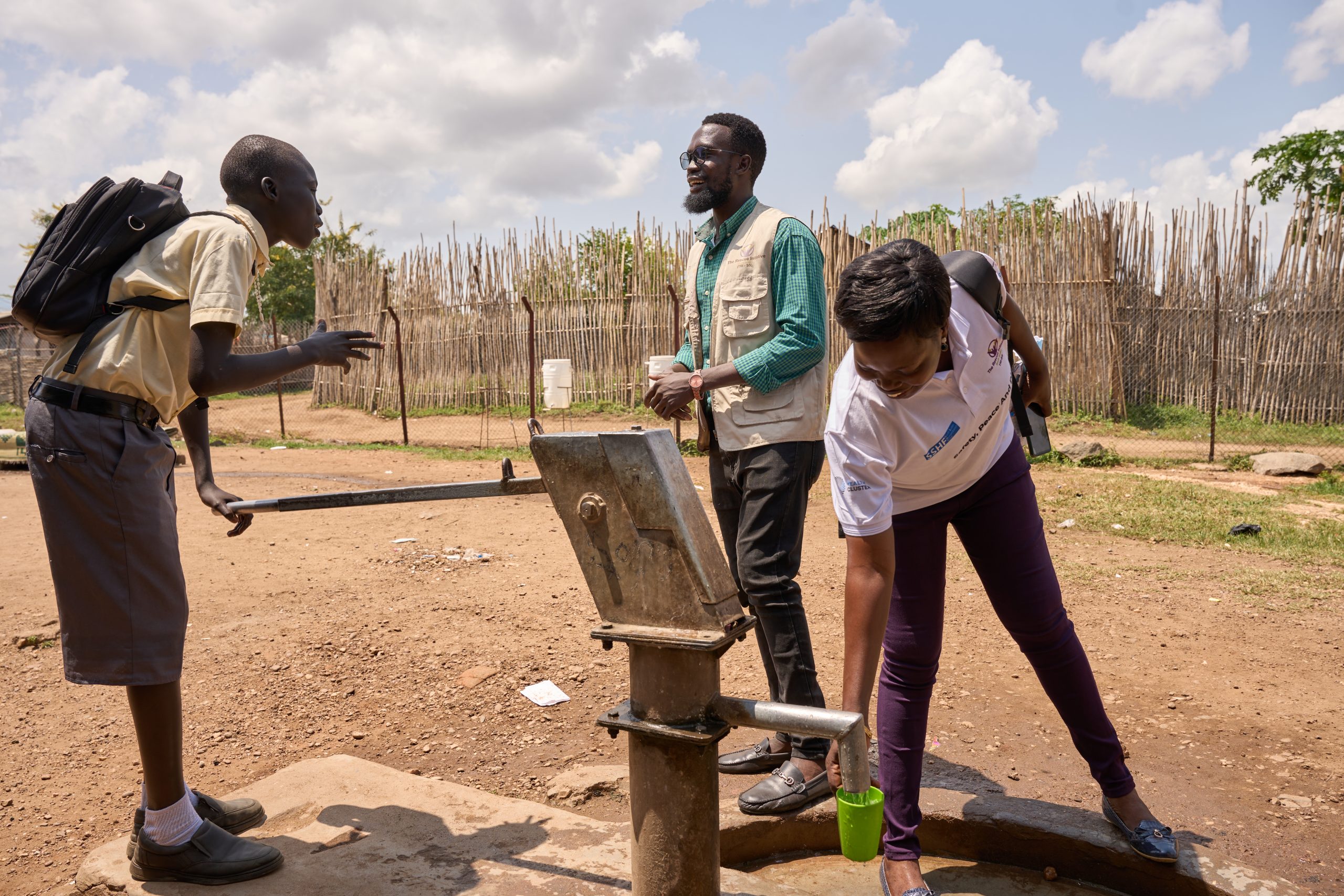 Steven Severio demonstrates the operation of his school's fresh water pump to TRI-SS staff. 